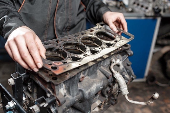 Mechanic fixing oil leaked blown head gasket