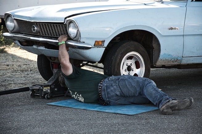 Man fixing failing electrical components on a automobile