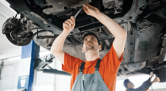 Mechanic checking signs of low transmission