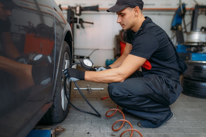 Mechanic checks the tire pressure of spare tire
