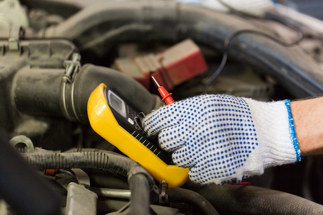 Mechanic troubleshooting a battery that continually drains