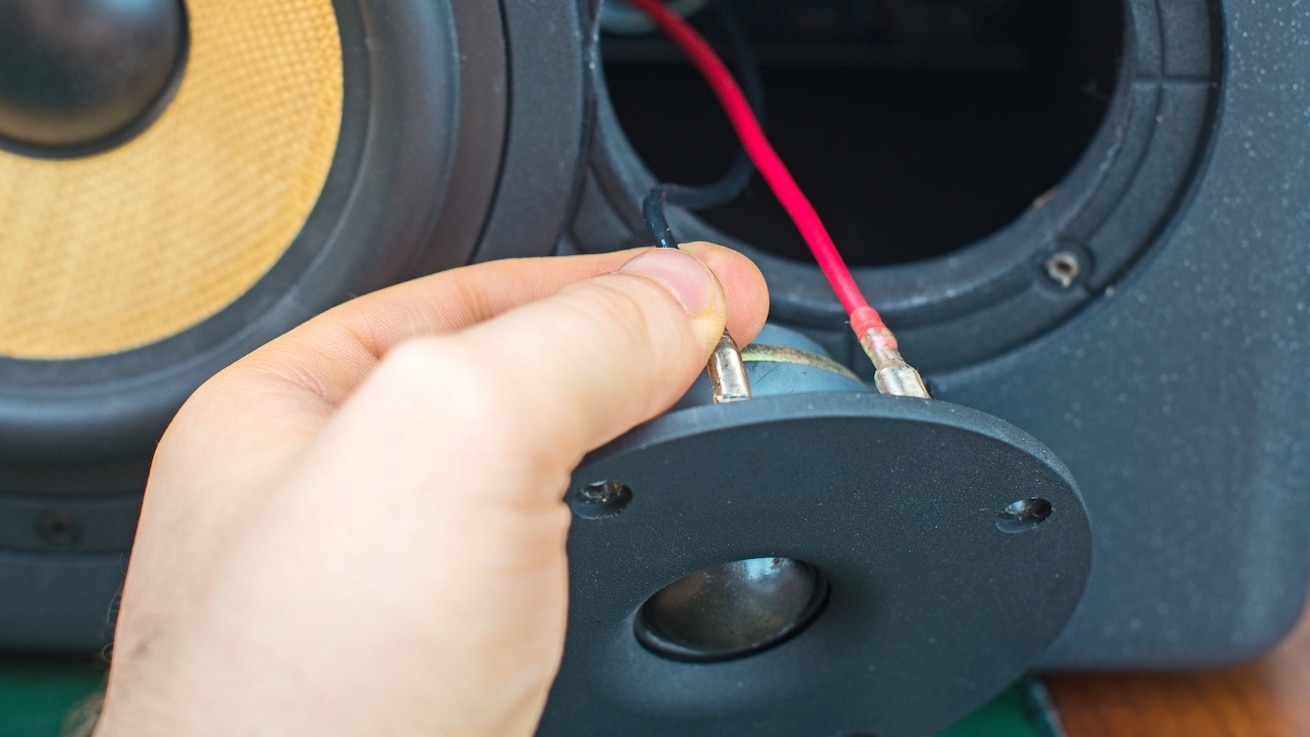 A person inspecting audio source quality to eliminate static noise